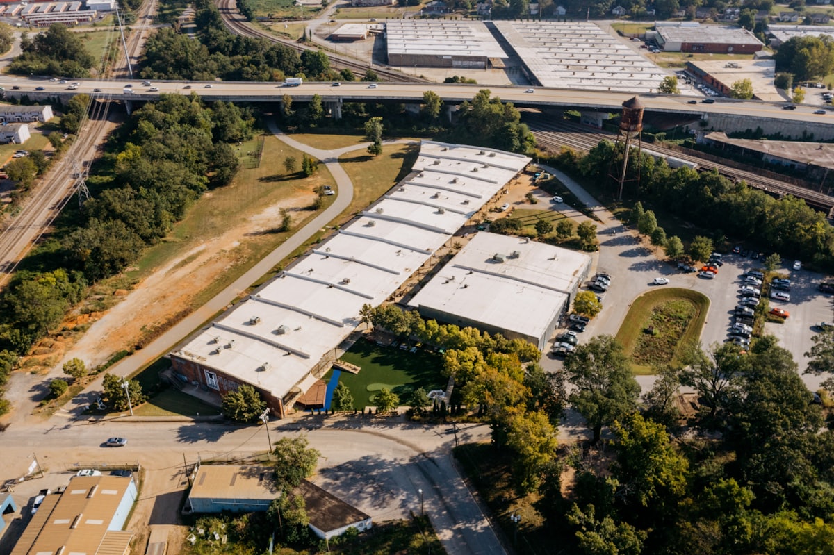 Aerial view of small commercial buildings with white flat roofs
